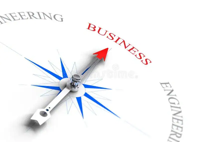 Compass needle pointing towards the word 'BUSINESS' with 'ENGINEERING' visible in the background on a white surface.